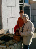 Elsie and her daughter Rose Anne make a donation.