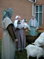 The shepherdess comforts a bleating kid.