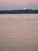 Clouds mask part of the sinking sun.